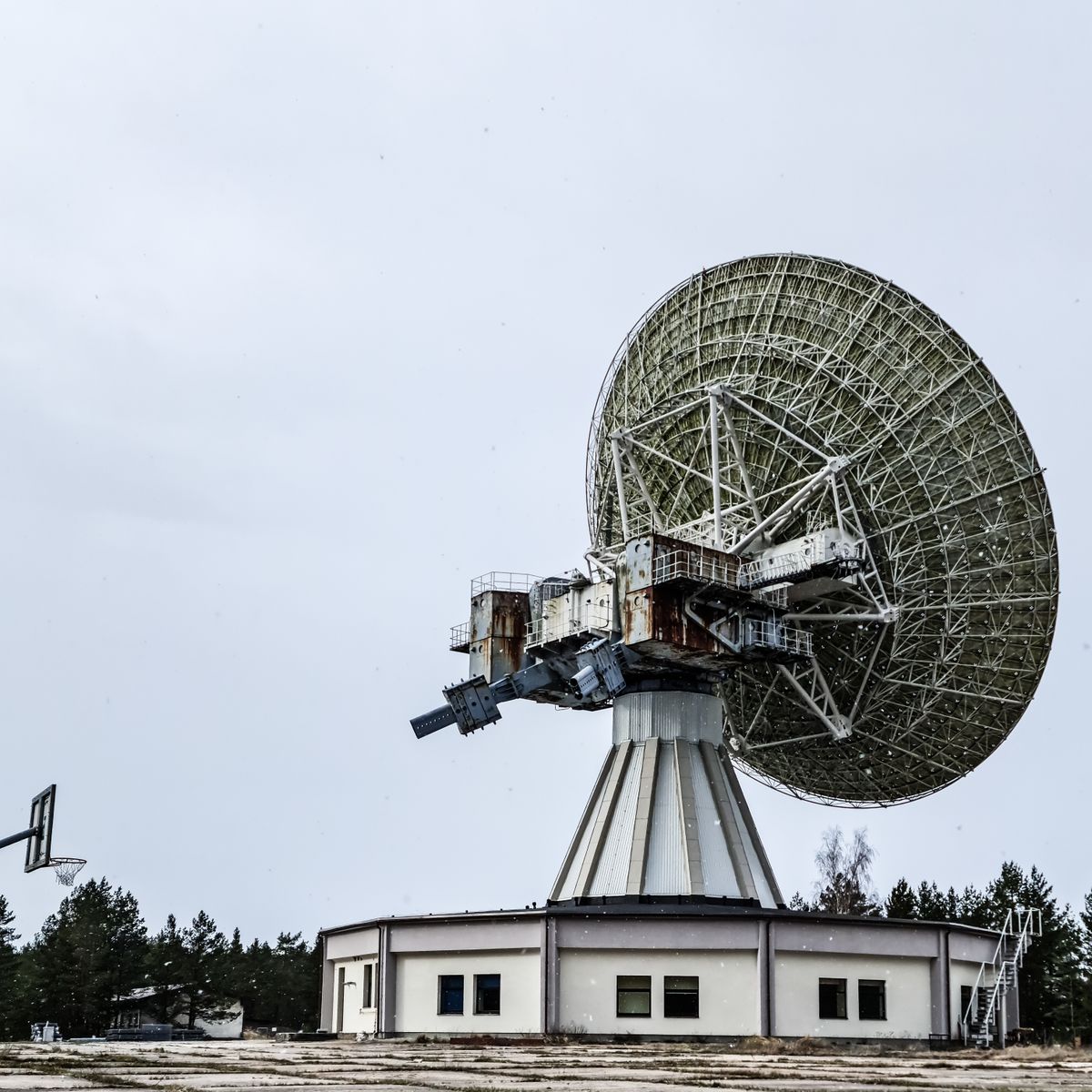Large satellite dish on a rooftop against the sky