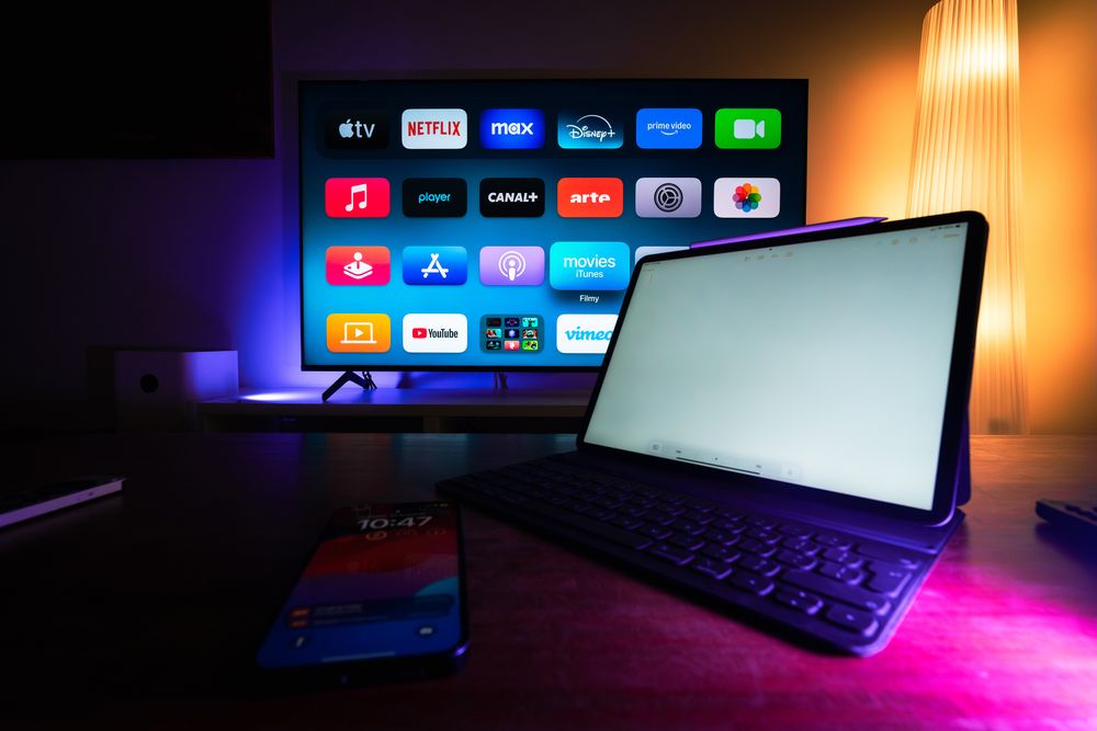 Smart TV and tablet displaying streaming apps in a modern home