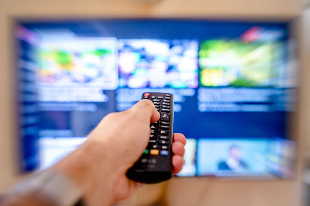 Close-up of a person using a television remote controller