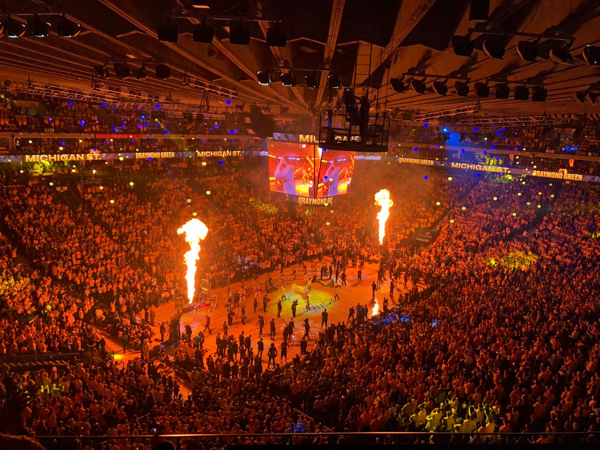 Packed arena crowd watching a live sporting event