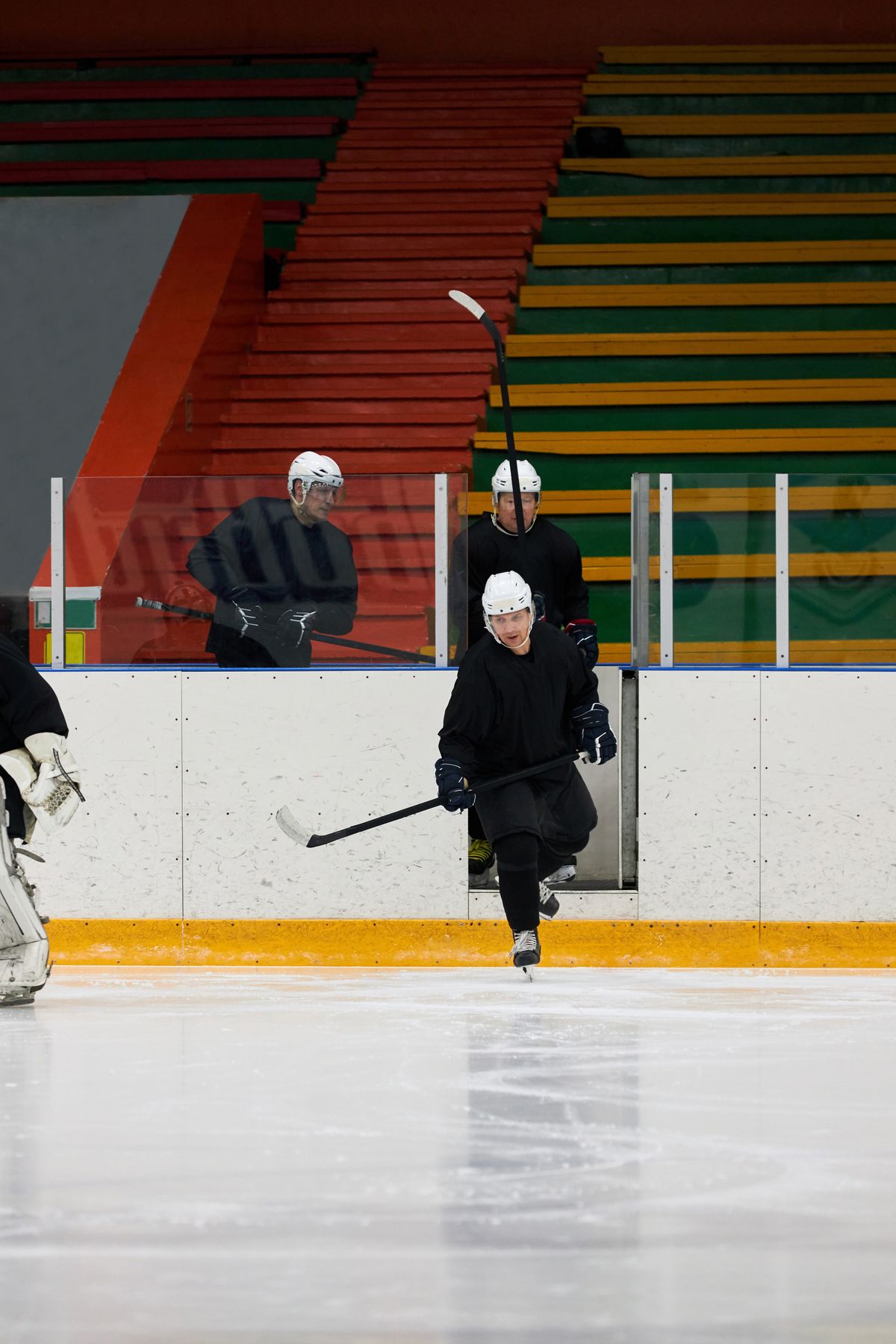 Ice hockey players stepping onto the rink before a game